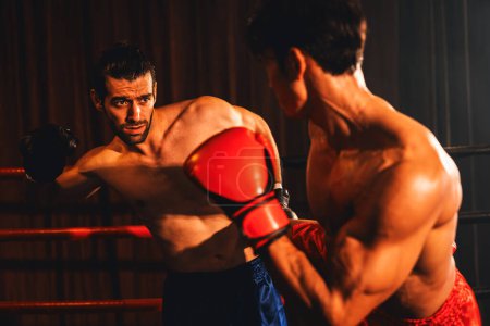 Photo for Asian and Caucasian Muay Thai boxer unleash their power in fierce boxing match. Thai boxer with strong muscular body exchanging punch and strike with relentless combat prowess. Impetus - Royalty Free Image