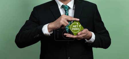 Photo for Corporate promoting sustainable and green business concept with businessman hold carbon neutral Net Zero symbol. Environmental protection effort using clean energy, zero CO2 pollution emission. Alter - Royalty Free Image