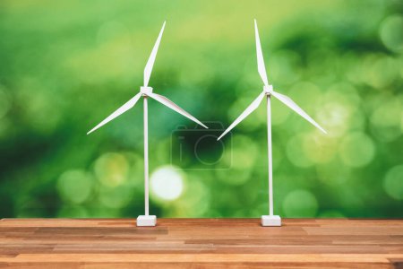Photo for Windmill or wind turbine farm model on office table design symbolizing modern solution for sustainable energy concept with zero CO2 pollution for clean and healthy ecology and environment. Alter - Royalty Free Image