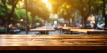 Photo for The empty wooden table top with blur background of outdoor cafe in the morning. Exuberant image. - Royalty Free Image