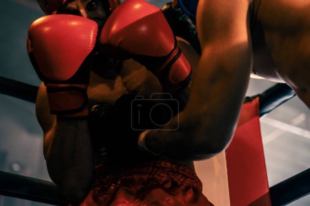 Two athletic and muscular body boxers with safety helmet or boxing head guard face off in fierce boxing match. Boxing fighter competitor fighting in the boxing ring. Impetus