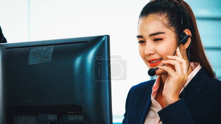 Photo for Business people wearing headset working in office to support remote customer or colleague. Call center, telemarketing, customer support agent provide service on telephone video conference call. Jivy - Royalty Free Image