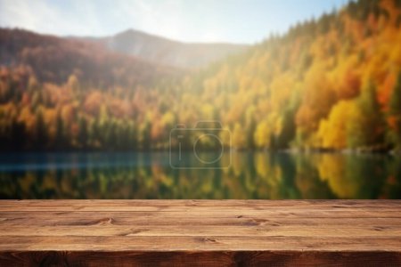 Foto de La mesa de madera vacía con fondo borroso de lago y montaña en otoño. Imagen exuberante. - Imagen libre de derechos