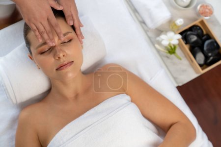 Photo for Panorama top view of woman enjoying relaxing anti-stress head massage and pampering facial beauty skin recreation leisure in dayspa modern light ambient at luxury resort or hotel spa salon. Quiescent - Royalty Free Image