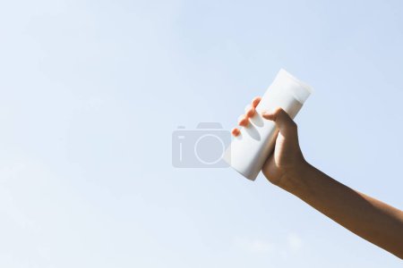 Photo for Recyclable plastic bottle held in hand up on sky background. Hand holding plastic waste for recycle reduce and reuse concept to promote clean environment with effective recycling management. Gyre - Royalty Free Image