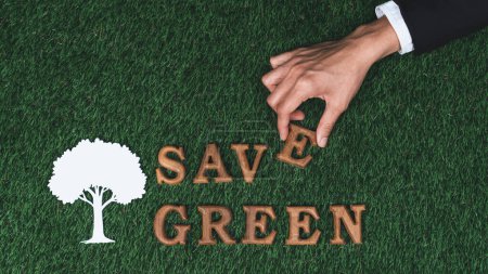 Photo for Hand arrange wooden alphabet in ecological awareness campaign with ECO icon design on biophilia green grass background to promote environmental protection for greener and sustainable future. Gyre - Royalty Free Image