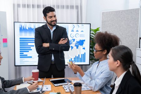Photo for Businessman presenting data analysis dashboard display on TV screen in modern meeting for marketing strategy. Business presentation with group of business people in conference room. Concord - Royalty Free Image