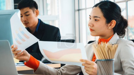 Photo for Business people working at table in modern office room while analyzing financial data report . Jivy - Royalty Free Image