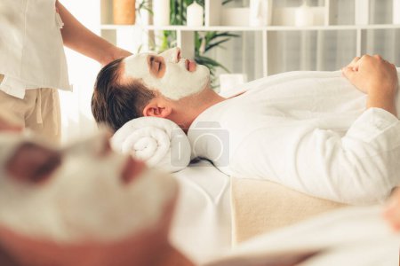 Photo for Serene ambiance of spa salon, couple indulges in rejuvenating with luxurious face cream massage with modern daylight. Facial skin treatment and beauty care concept. Quiescent - Royalty Free Image