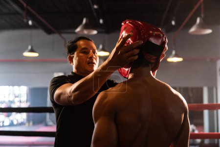 Photo for Referee explain rules and make preparation before give signal for the boxing match, boxer with safety helmet or head guard on the ring, ready to fight. Impetus - Royalty Free Image