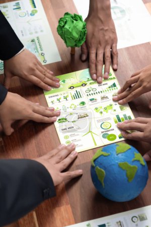 Cohesive group of business people forming jigsaw puzzle pieces in environmental awareness symbol as eco corporate responsibility for community and sustainable solution for greener Earth. Quaint