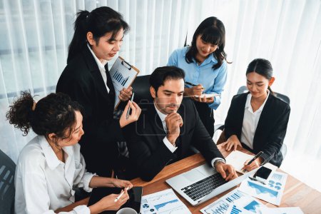 Photo for Diverse group of business analyst team analyzing financial data report paper on office table. Chart and graph dashboard by business intelligence analysis for strategic marketing planning Meticulous - Royalty Free Image
