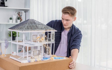 Photo for Architect designer reviewing house frame model with no wall, brainstorming interior design and improvement idea with actual home scale. Professional and creativity in architectural design. Iteration - Royalty Free Image