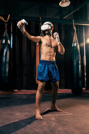 Photo for Boxer training utilizing VR technology or virtual reality, wearing VR headset with immersive boxing training technique using controller to enhance his skill in boxing simulator environment. Impetus - Royalty Free Image