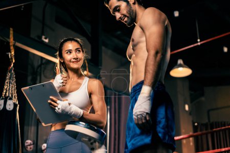Photo for Muay Thai boxer step on weight scale for boxing class designation by weight measurement before boxing fight match. Dedicated athlete fitness and physical boxers body readiness. Impetus - Royalty Free Image
