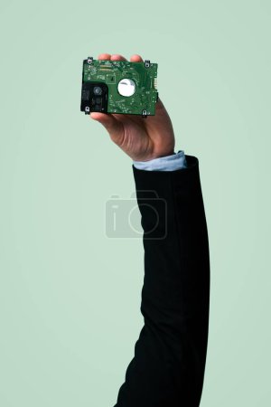 Photo for Businessmans hand holding electronic waste on isolated background. Eco-business recycle waste policy in corporate responsibility. Reuse, reduce and recycle for sustainability environment. Quaint - Royalty Free Image