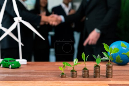 Photo for Organic money growth investment concept shown by stacking piles of coin with sprout or baby plant on top. Financial investments rooted and cultivating sustainable clean energy with nature. Quaint - Royalty Free Image