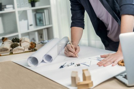 Photo for Drafting interior house design by architect designer planning home layout on blueprint paper on office desk. Architect carefully drawing home interior layout with pencil and tool. Iteration - Royalty Free Image