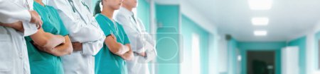 Confident medical staff team with doctor nurse and healthcare specialist professions people in hospital or clinic corridor. Medical and healthcare community in panoramic banner. Neoteric