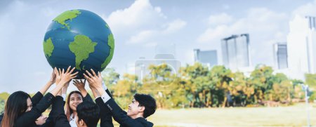 Photo for Earth day concept with big Earth globe held by group of asian business people team promoting environmental awareness with environmentally sustainability and ESG principle for brighter future. Gyre - Royalty Free Image
