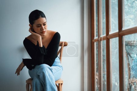 Photo for Depressed young Asian woman with mental health problem in mind need uttermost treatment from overthinking fatigue, disruptive thought, dissocial, anxiety and other mental health disorders . - Royalty Free Image