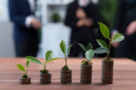 Photo for Organic money growth investment concept shown by stacking piles of coin with sprout or baby plant on top. Financial investments rooted and cultivating wealth in harmony with nature. Quaint - Royalty Free Image