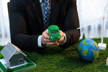 Photo for Eco business and save Earth concept shown by businessman or CEO holding paper globe in office with eco friendly mockup to promote CO2 and carbon footprint reduction for greener future. Quaint - Royalty Free Image