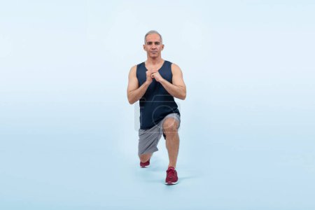 Photo for Active and fit physique senior man warming up before exercise on isolated background. Healthy lifelong senior people with fitness healthy and sporty body care lifestyle concept. Clout - Royalty Free Image