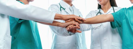 Photo for Group of medical staff doctor nurse and healthcare specialist profession coordinating synergy hand in hospital. Medical teamwork and healthcare cooperation in panoramic banner background. Neoteric - Royalty Free Image
