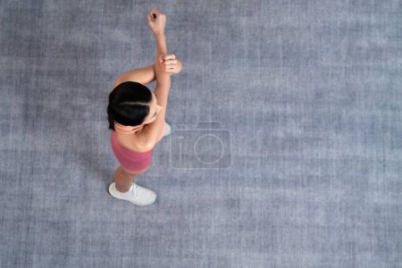 Photo for Young attractive asian woman in sportswear stretching before fitness exercise routine. Body workout with healthy athletic woman warming up. Top view panorama. Vigorous - Royalty Free Image