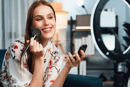 Photo for Woman influencer shoot live streaming vlog video review makeup utmost social media or blog. Happy young girl with cosmetics studio lighting for marketing recording session broadcasting online. - Royalty Free Image