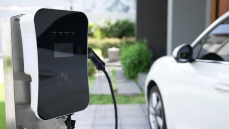 Photo for Home charging station provides an eco-friendly sustainable power supply for EV cars. Progressive concept for future green energy storage for electric vehicles. - Royalty Free Image