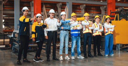 Photo for Confident and smiling lineup of factory worker, engineer, manager and foreman stand on-site within heavy industrial manufacturing factory with sense of teamwork and determination Panorama Exemplifying - Royalty Free Image