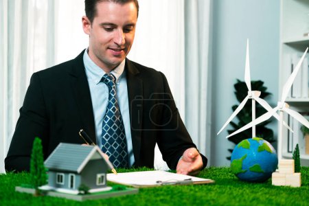 Photo for Businessman or CEO in office signing environmental regulation agreement to save Earth with sustainable energy utilization and CO2 reduction for greener future. Quaint - Royalty Free Image