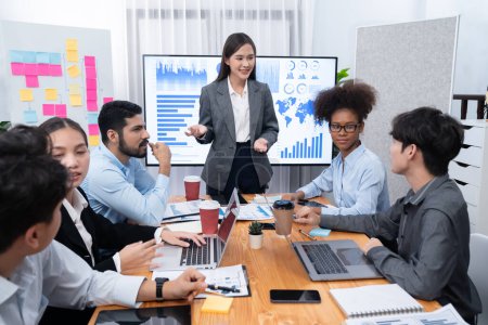 Photo for Young asian businesswoman presenting data analysis dashboard on TV screen in modern meeting. Business presentation with group of business people in conference room. Concord - Royalty Free Image