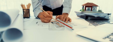 Photo for Interior architect designer at workstation table designing house interior blueprint and choosing mood board samples. Creative hand drawing sketch plan for house renovation or design concept. Insight - Royalty Free Image