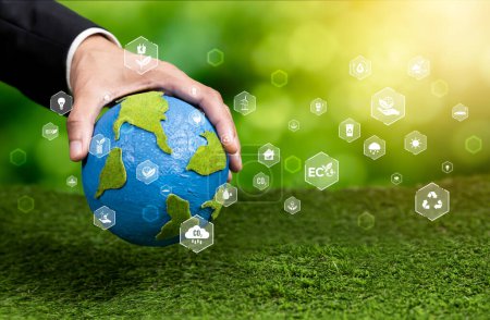 Photo for Businessman holding Earth with eco friendly icon design symbolize business company commitment to protect planet Earths ecosystem with net zero technology and ESG practice. Reliance - Royalty Free Image