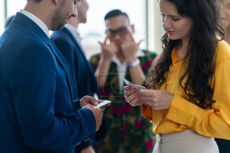 Photo for Successful businesswoman holding the name card during talking to manager about their cooperation. Cropped image of exchanging name card between businessman and businesswoman. Side view. Intellectual. - Royalty Free Image