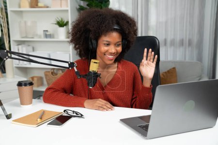 Photo for Host channel of beautiful African woman talking in online broadcast teaching marketing influencer, with listeners in broadcast or online. Concept of anywhere at work place. Tastemaker. - Royalty Free Image