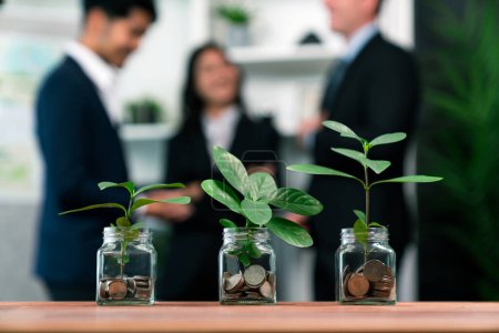 Photo for Organic money growth investment concept shown by money savings in glass jar. Financial investments rooted and cultivating wealth in harmony with nature. Quaint - Royalty Free Image