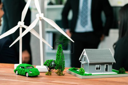 Photo for Mockup electric car with eco-friendly energy infrastructure on table with blurred background of productive business team meeting to contribute natural preservation and sustainable future. Quaint - Royalty Free Image