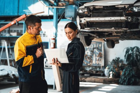 Photo for Two vehicle mechanic working together, conduct car inspection with laptop. Automotive service technician in uniform carefully make diagnostic troubleshooting to identify error. oxus - Royalty Free Image