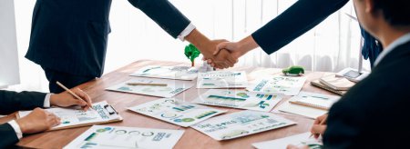 Photo for Business people hand shake in Eco corporate meeting room after made successful agreement deal on eco-friendly products. Sustainability and environmental protection in business cooperation.Trailblazing - Royalty Free Image