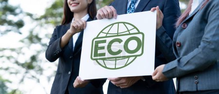 Photo for Group of business people stand united, holding eco-friendly idea and concept for environmental awareness campaign embracing eco friendly and greener environment with inspire positive change.Gyre - Royalty Free Image