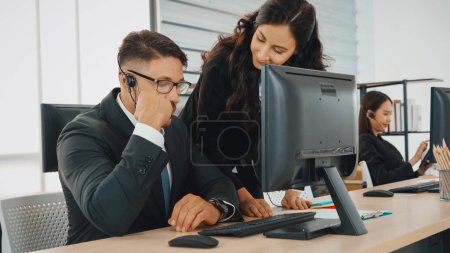 Photo for Business people wearing headset working in office to support remote customer or colleague. Call center, telemarketing, customer support agent provide service on telephone video conference call. Jivy - Royalty Free Image