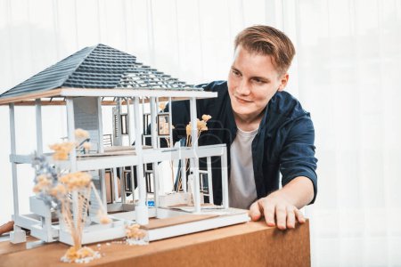 Photo for Architect designer reviewing house frame model with no wall, brainstorming interior design and improvement idea with actual home scale. Professional and creativity in architectural design. Iteration - Royalty Free Image