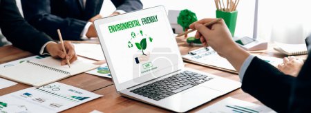 Téléchargez les photos : Business people in green corporate company planning eco-friendly and environmental conservative to reduce CO2 and implement net zero policy in meeting room with eco idea on laptop screen. Des pionniers - en image libre de droit