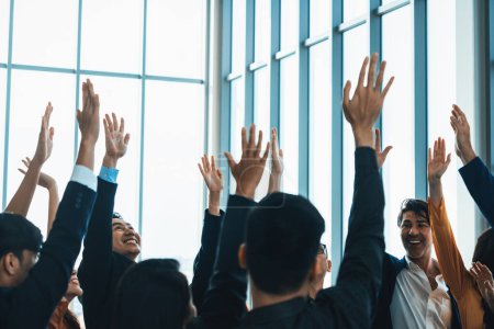Photo for Successful business people raised their hands up for voting showing their approval volunteering in the office seminar with happiness. Smile managers put their hands up in the air. Intellectual. - Royalty Free Image