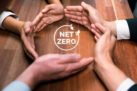 Photo for Top view group of business people forming circle hand around eco-friendly net zero icon on meeting table. Alternative clean technology technology investment for greener sustainable future. Quaint - Royalty Free Image