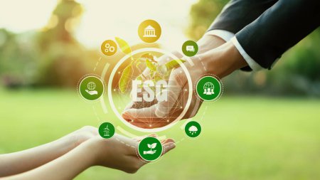 Photo for Businessman and little kid holding seedling plant together with ESG and eco icon. Green business investing on environment sustainability to provide greener future for next generation. Panorama - Royalty Free Image